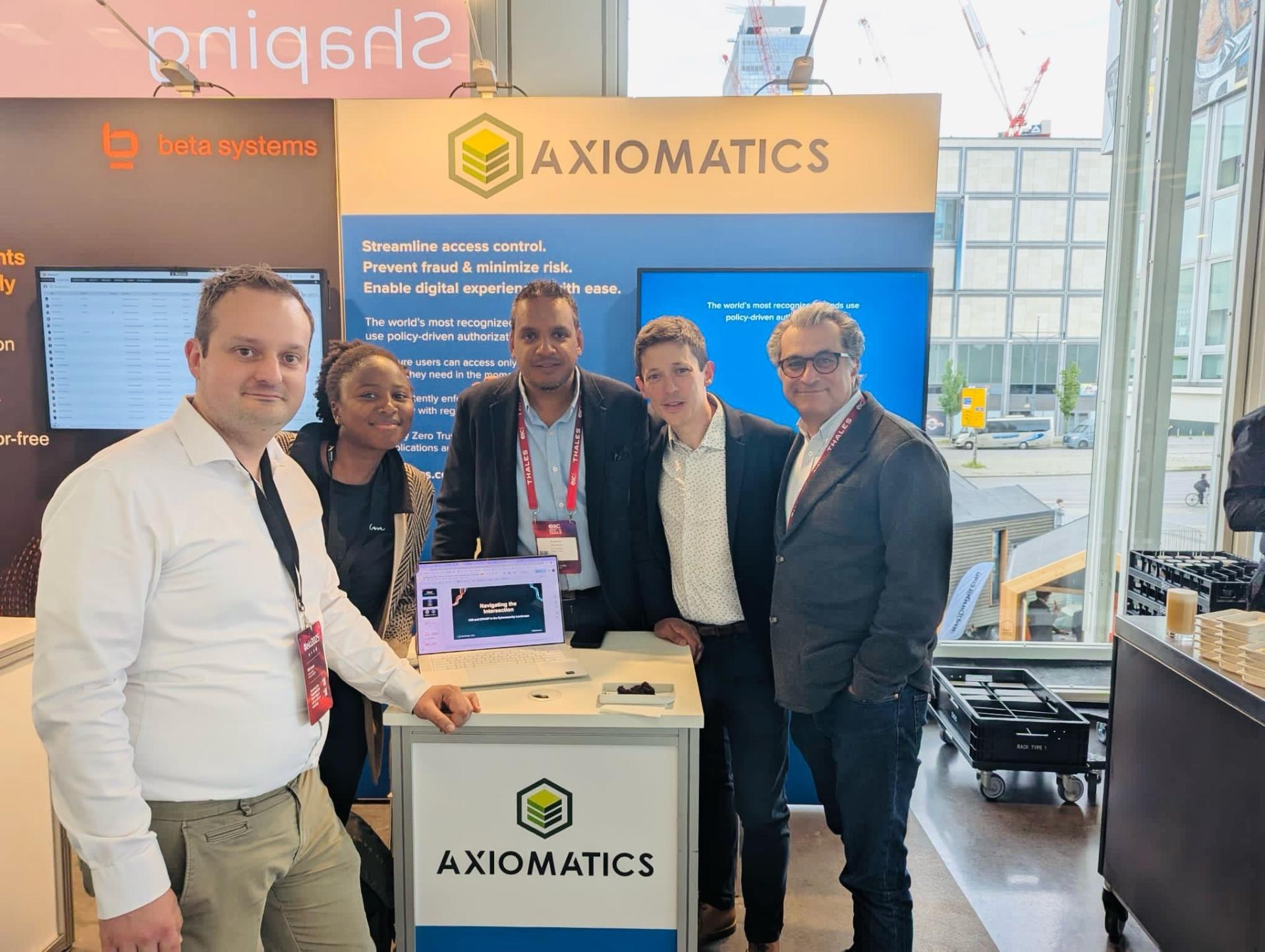 The Ariovis team with the Axiomatics team on the Axiomatics booth at the European Identity and Cloud Conference 2025 in Berlin.